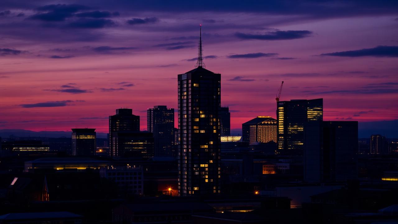 Manchester city skyline at dusk with lit apartment towers
